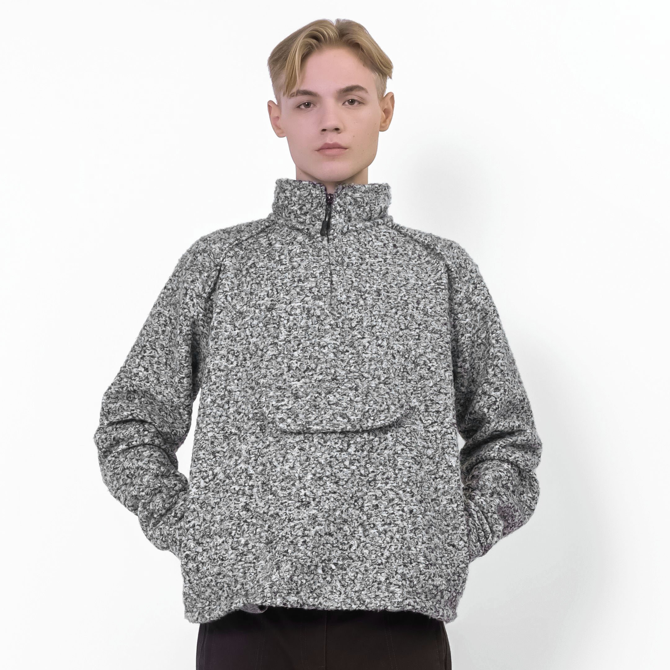 Front view of man wearing a grey boucle zip-up jacket showcasing the jacket’s fit and textured fabric detail.