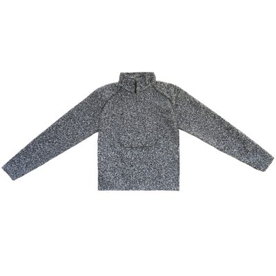 Flat lay photo of grey, white, and black boucle sweater.