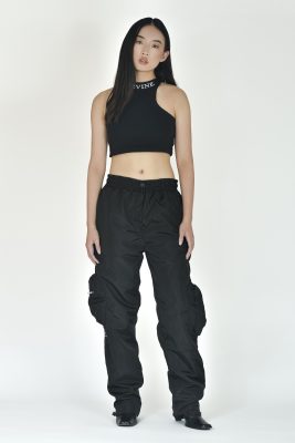 Cargo pants for men in black, worn with a black crop top.