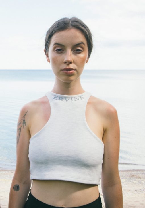 model is wearing our reverse racer crop top in the color heather grey