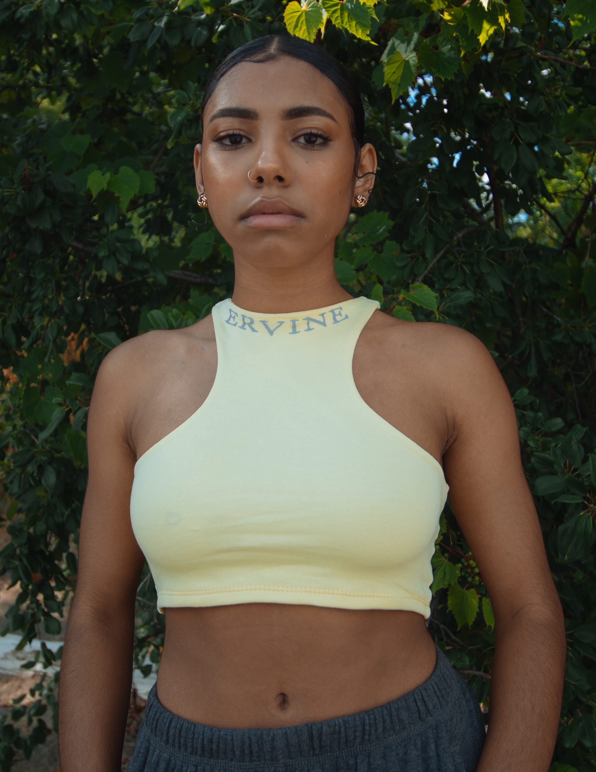 model is wearing our reverse racer crop top in the color ice white