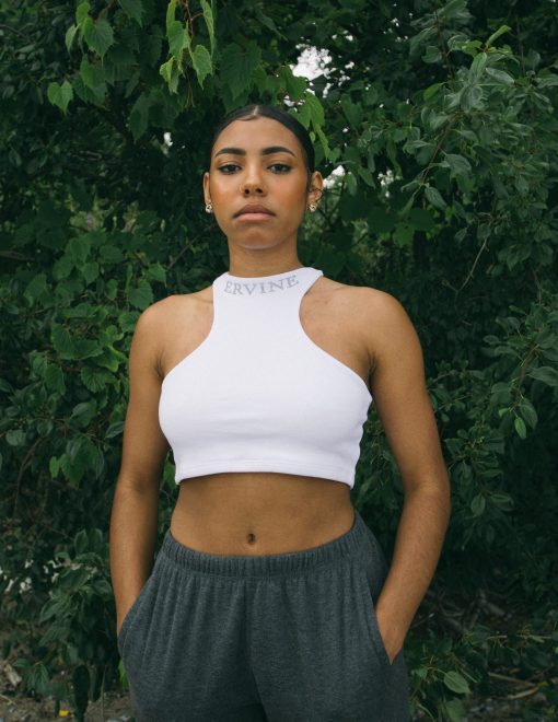 model is wearing our reverse racer crop top in the color ice white