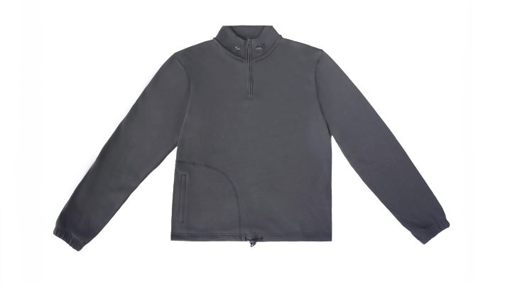 Flat lay photo of a grey quarter zip sweater with adjusters